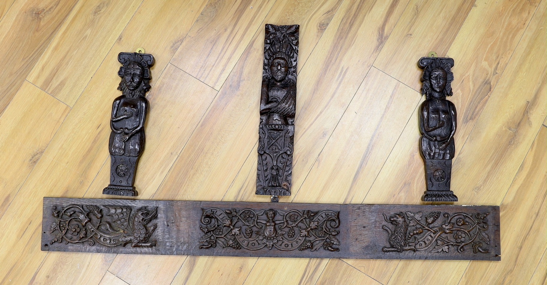 A 17th carved oak figural corbel, a pair of carved oak corbels and a carved oak frieze 14x19cm